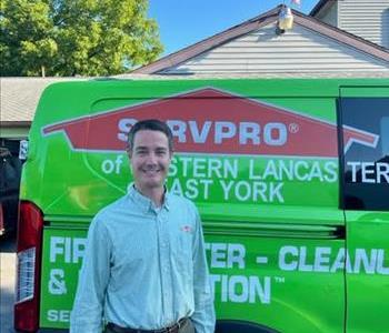 Ben Ritter standing in front of servpro van