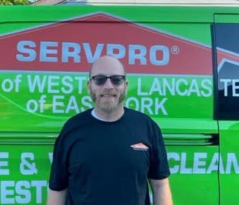 Joe Cunningham in front of SERVPRO van